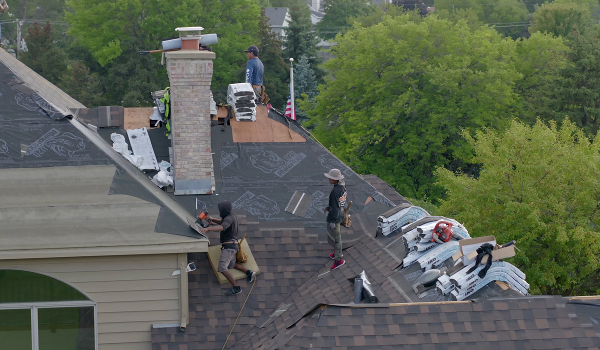men repairing house roof