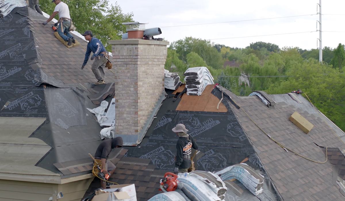 Men repairing the house roof.