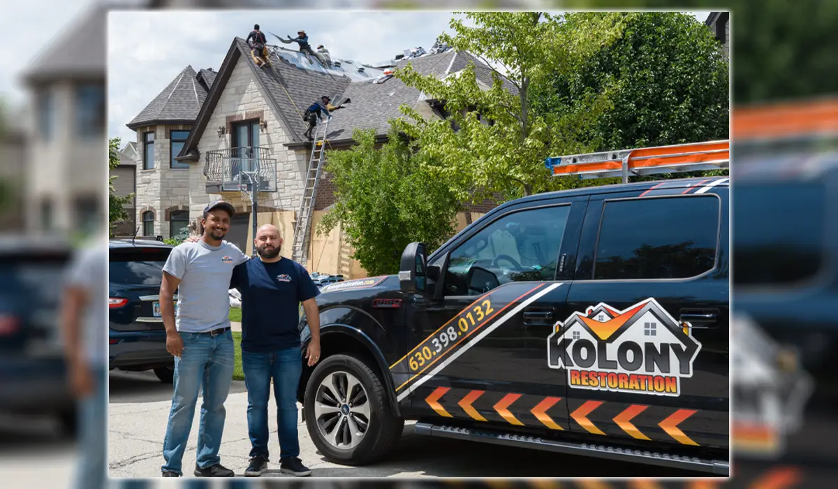 Men are fixing roofs behind two men in company cars. Roof restoration experts for your home.